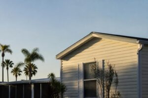 Exterior roofline and wall of a well-maintained manufactured home in a Florida community